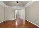Spacious main bedroom with hardwood floors and trey ceiling at 1850 Westwind Dr, Cumming, GA 30041