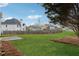 Expansive backyard with lush green grass and a view of the surrounding neighborhood at 4776 Trilogy Park Trl, Hoschton, GA 30548