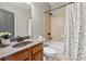 Cozy bathroom with a large mirror, shower-tub combo, and granite countertop at 4776 Trilogy Park Trl, Hoschton, GA 30548