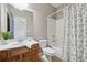 Bathroom featuring a wood vanity, white countertops, toilet, and shower/tub combo with curtain at 4776 Trilogy Park Trl, Hoschton, GA 30548