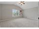 Bright bedroom with ceiling fan and large window, carpet flooring, and spacious feel at 4776 Trilogy Park Trl, Hoschton, GA 30548