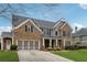 Beautiful two-story brick home with a two-car garage and manicured lawn at 4776 Trilogy Park Trl, Hoschton, GA 30548