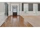 Elegant foyer with dark hardwood floors and views into the formal living and dining rooms at 4776 Trilogy Park Trl, Hoschton, GA 30548