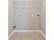 Utility room with tile flooring and hookups for a washer and dryer at 4776 Trilogy Park Trl, Hoschton, GA 30548