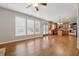 Open living space featuring hardwood floors, fireplace, and seamless connection to the kitchen at 4776 Trilogy Park Trl, Hoschton, GA 30548
