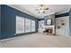 Cozy living room featuring a fireplace, built-in bookshelves, and plenty of natural light at 4776 Trilogy Park Trl, Hoschton, GA 30548