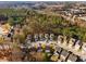An aerial view shows houses nestled among green trees in a neighborhood at 6439 Grey Fox Way, Riverdale, GA 30296