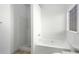 Clean bathroom with white fixtures featuring a bathtub and a standing shower at 6439 Grey Fox Way, Riverdale, GA 30296
