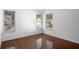 A sunlit bedroom with gleaming hardwood floors and three large windows at 6439 Grey Fox Way, Riverdale, GA 30296