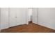 Bright bedroom features hardwood floors, white walls and trim, and closet at 6439 Grey Fox Way, Riverdale, GA 30296