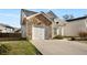 Exterior view of an attached garage with stone accents and a concrete driveway at 6439 Grey Fox Way, Riverdale, GA 30296