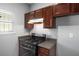 The kitchen features wooden cabinets, a gas range, and ample counter space at 6439 Grey Fox Way, Riverdale, GA 30296