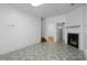 Cozy living room featuring a fireplace, tile flooring, and access to a staircase at 6439 Grey Fox Way, Riverdale, GA 30296