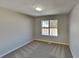 Clean and cozy bedroom with neutral carpet and one bright window at 7021 Hillcrest Chase Ln, Austell, GA 30168