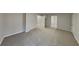 Large bedroom with carpet and multiple doorways at 7021 Hillcrest Chase Ln, Austell, GA 30168