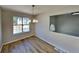 Dining room features new flooring and a hanging light fixture at 7021 Hillcrest Chase Ln, Austell, GA 30168