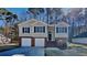 Charming two-story home features a two-car garage and a beautifully landscaped front yard at 7021 Hillcrest Chase Ln, Austell, GA 30168
