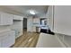Modern kitchen features white cabinets, stainless steel appliances, and laminate flooring at 7021 Hillcrest Chase Ln, Austell, GA 30168