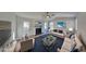 Bright living room offers modern ceiling fan, fireplace, and is virtually staged at 7021 Hillcrest Chase Ln, Austell, GA 30168
