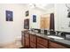Bathroom with double sink vanity and granite countertops and tile shower with curtain at 200 River Vista Dr # 736, Atlanta, GA 30339