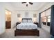 This well-lit bedroom features a ceiling fan, large window, and a door to the bathroom at 200 River Vista Dr # 736, Atlanta, GA 30339