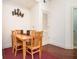 Cozy dining area featuring a wooden table set for four, adjacent to an updated kitchen and an artful wall decor at 200 River Vista Dr # 736, Atlanta, GA 30339