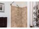 Tiled shower stall with adjustable shower head and towel rack with decorative towels at 200 River Vista Dr # 736, Atlanta, GA 30339