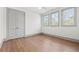 Bright bedroom features three windows, hardwood floors, and a double-door closet with modern trim at 375 Chattahoochee St, Roswell, GA 30075