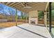 Covered patio with a brick fireplace and concrete flooring at 375 Chattahoochee St, Roswell, GA 30075