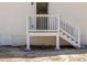 Rear exterior featuring a small white deck with stairs leading to a back entrance and the home's lower access point at 1190 Dallas Hwy, Villa Rica, GA 30180
