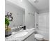 Bright bathroom featuring a granite countertop, modern fixtures and a shower-tub combination at 1190 Dallas Hwy, Villa Rica, GA 30180