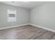 Minimalist bedroom offers plenty of natural light and wood-look flooring at 1190 Dallas Hwy, Villa Rica, GA 30180