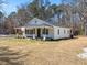 Newly renovated home with white exterior and a cozy front porch, surrounded by a green lawn at 1190 Dallas Hwy, Villa Rica, GA 30180