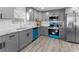 Updated kitchen showcases gray cabinets, stainless steel appliances, and granite countertops at 1190 Dallas Hwy, Villa Rica, GA 30180