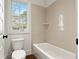 Cozy bathroom features a soaking tub and window at 2849 Parkridge Ne Dr, Brookhaven, GA 30319