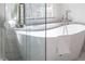 Close up of soaking tub with window and fixtures in bright bathroom with glass shower at 2849 Parkridge Ne Dr, Brookhaven, GA 30319