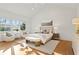 Sun-filled bedroom featuring a vaulted ceiling, hardwood floors and sitting area with bench and accent chairs at 2849 Parkridge Ne Dr, Brookhaven, GA 30319
