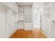 Walk-in closet featuring custom shelving and wood flooring at 2849 Parkridge Ne Dr, Brookhaven, GA 30319