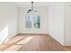 Bright dining room with wood floors, modern chandelier, and large windows offering great outdoor views at 2849 Parkridge Ne Dr, Brookhaven, GA 30319