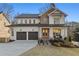 Stunning two-story home with a two-car garage and beautiful brick and white siding at 2849 Parkridge Ne Dr, Brookhaven, GA 30319