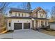 Beautiful two-story home with a brick and white siding, a large garage, and a covered front porch at 2849 Parkridge Ne Dr, Brookhaven, GA 30319