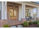 Inviting front porch featuring brick accents, stylish seating, and elegant architectural details at 2849 Parkridge Ne Dr, Brookhaven, GA 30319