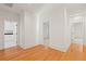 Bright hallway featuring hardwood floors, white walls and trim, and doorways to other rooms at 2849 Parkridge Ne Dr, Brookhaven, GA 30319