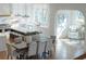 Spacious kitchen connected to a dining and sitting area, featuring white cabinets and modern appliances at 2849 Parkridge Ne Dr, Brookhaven, GA 30319