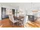 Open-concept kitchen and dining area with white cabinets, stainless steel appliances, and hardwood flooring at 2849 Parkridge Ne Dr, Brookhaven, GA 30319