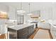 Modern kitchen with a center island, white countertops, stainless steel appliances, and hardwood floors at 2849 Parkridge Ne Dr, Brookhaven, GA 30319