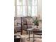 Cozy seating area featuring two armchairs, round tables, and large windows for ample natural light at 2849 Parkridge Ne Dr, Brookhaven, GA 30319
