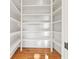 Walk-in pantry with extensive shelving for ample storage, featuring hardwood floors at 2849 Parkridge Ne Dr, Brookhaven, GA 30319