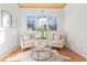 Bright sitting room featuring a wooden floor, white walls, chairs, round table, and a large window at 2849 Parkridge Ne Dr, Brookhaven, GA 30319