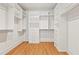 Organized walk-in closet featuring white shelving, drawers, and wood floor at 2849 Parkridge Ne Dr, Brookhaven, GA 30319